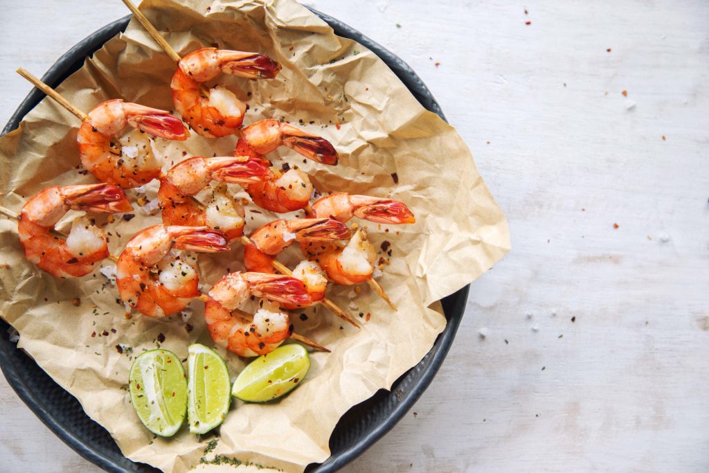 Grilled shrimp on skews with lime slices