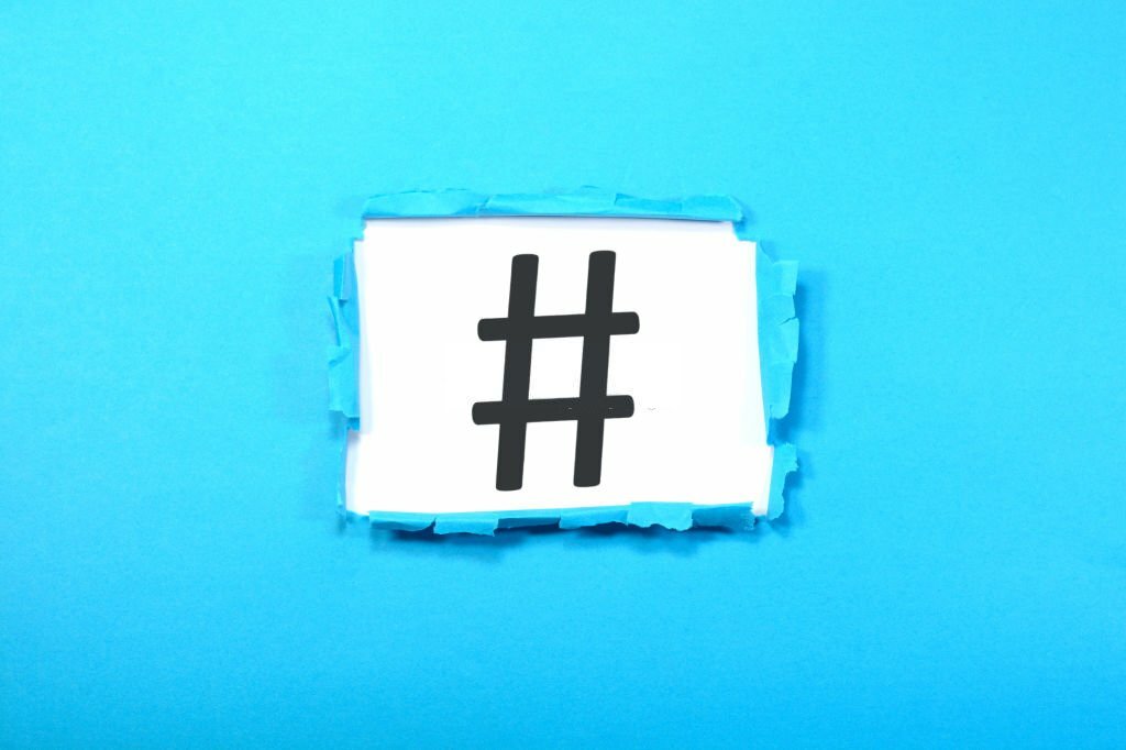 A hashtag sign is shown on a blue ripped paper.